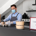 man-with-apron-preparing-food-takeaway